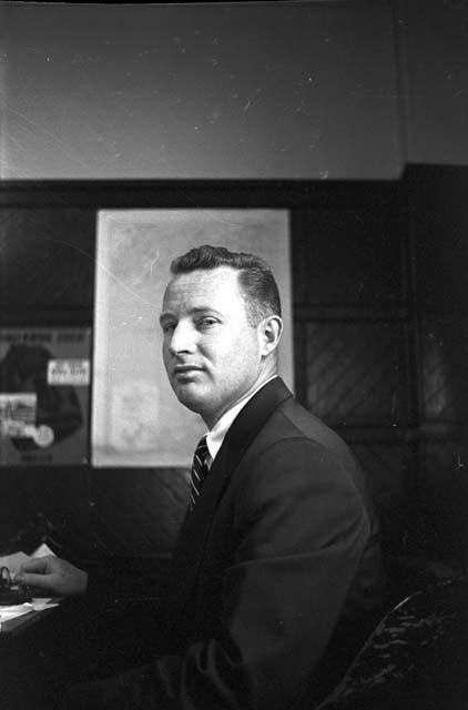 Portrait of man in suit sitting at desk