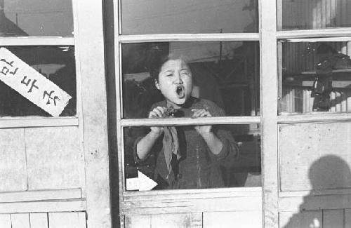 Portrait of woman shouting through window