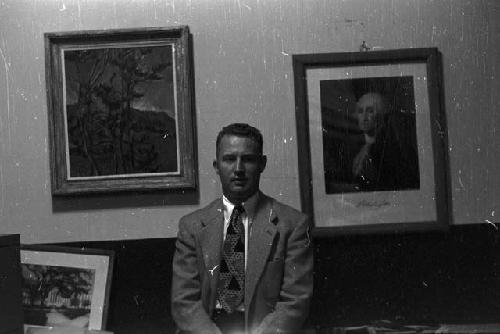 Portrait of man wearing suit sitting in office