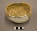 Undecorated pottery bowl--restored