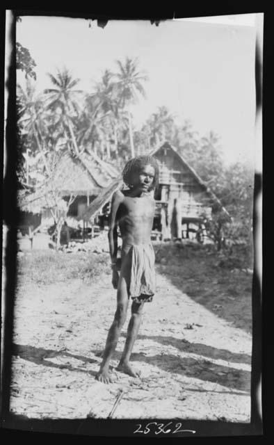 Native Man in front of Hut