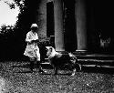 Woman with dog in front of house