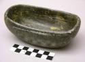 Dish, ground stone, flat base, oblong, deep bowl