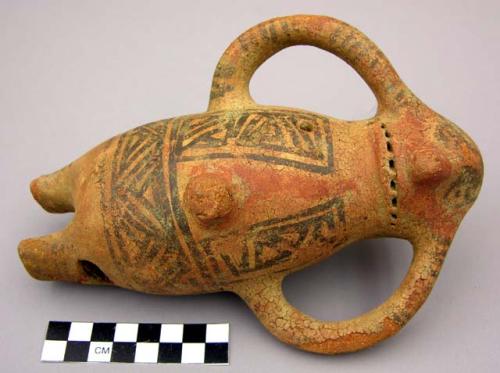 Figurine ocarina.  Red with black motifs; 2 arms and 1 tail