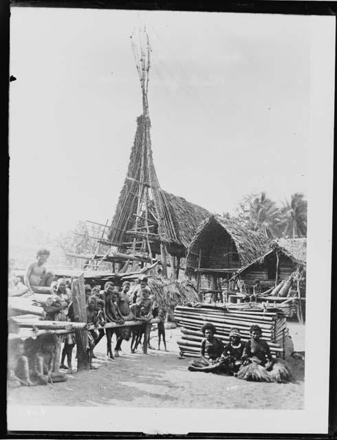 People in front of huts