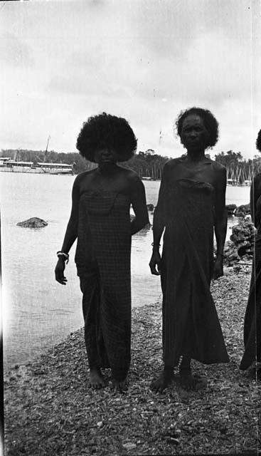 Women standing on beach in native garb