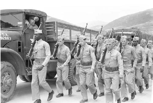Soldiers and trucks en route to U.N. cemetery