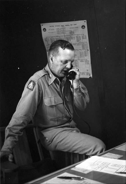 Soldier resting on arm rest talking on the phone