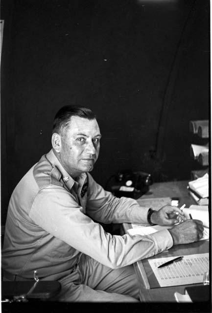 Soldier sitting on chair writing on paper