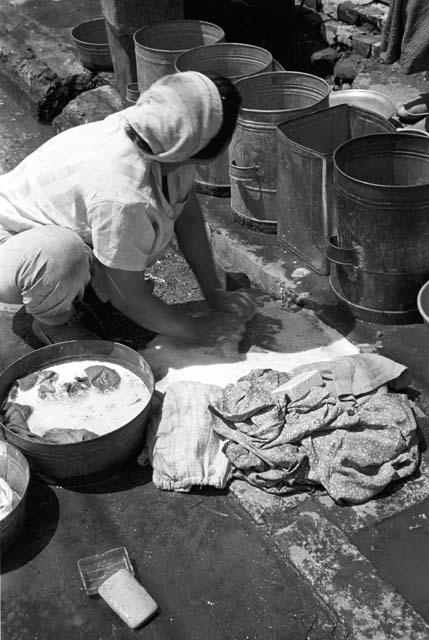 Woman scrubbing street