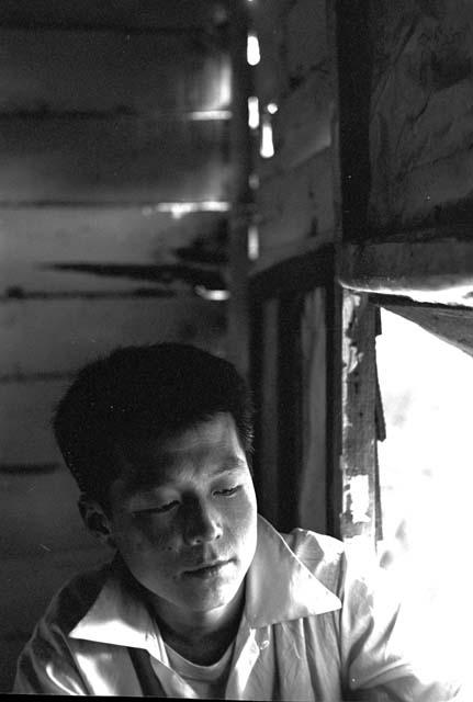 Portrait of boy sitting by window