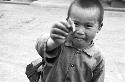 Portrait of boy holding up snack