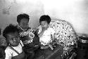 Children sitting on desk eating