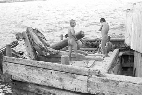 Nude boys on old deck