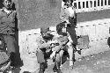 Portrait of soldier and woman sitting on curb