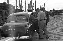 Soldiers on road getting into car