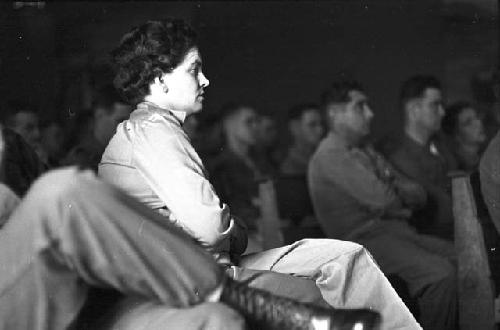 Portrait of woman in audience sitting listening to speech