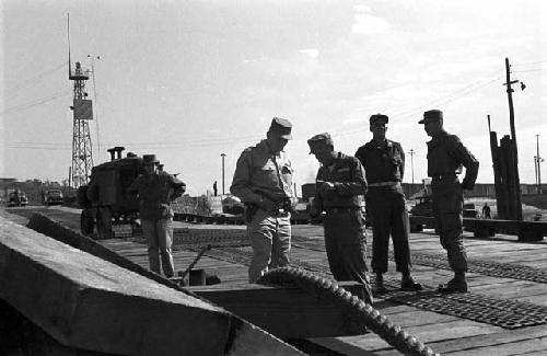 Soldiers gathered on platform discussing plans