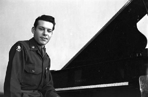 Portrait of officer at piano facing camera