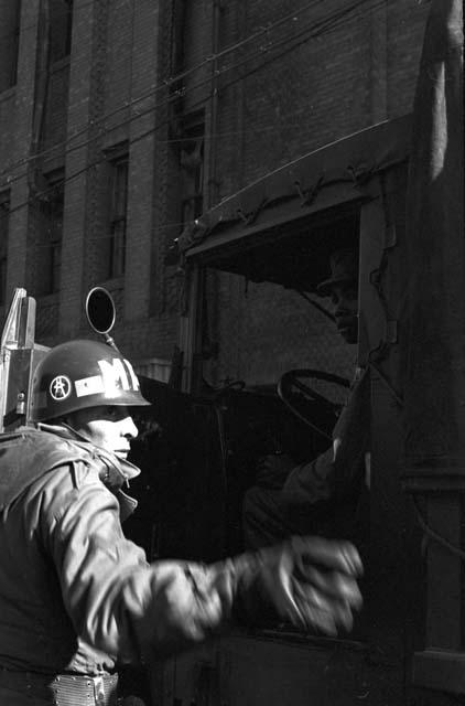 Soldier directing truck traffic