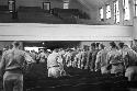 Portrait of soldiers exiting auditorium