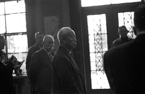 Portrait of man in suit during gathering between suits and soldiers