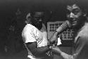 Trainer taping boxer's hands before match