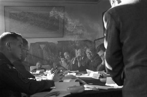 Portrait of suits and soldiers as smoke clouds air