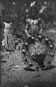 Man with large decorated hat standing on road