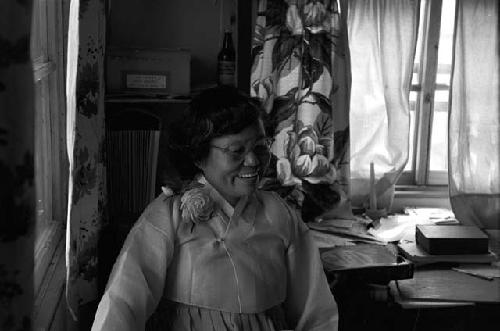 Portrait of woman wearing gown inside home