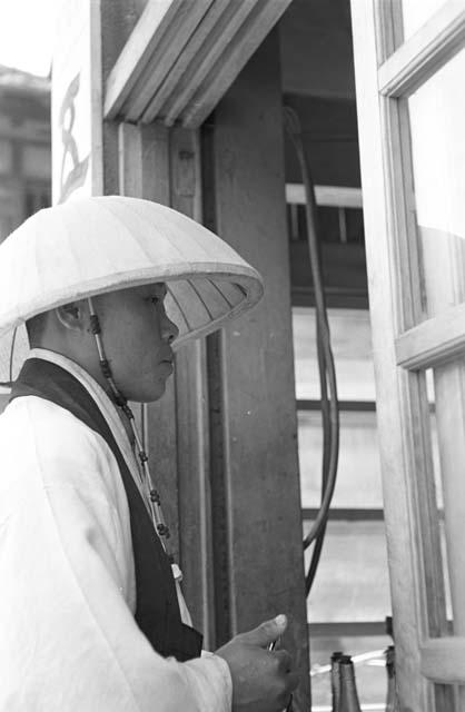 Portrait of man dressed in garment walking through door