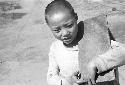 Portrait of boy carrying wood on shoulder