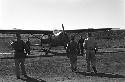 Soldiers walking towards plane on air strip