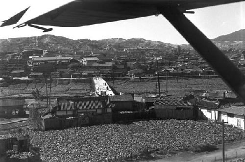 Portrait of rising hills and mountains from plane early during lift off