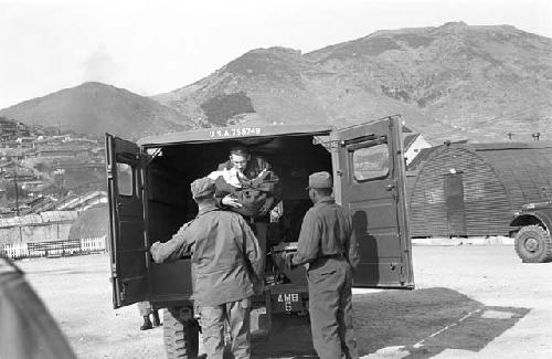 Soldier carrying baby out of truck