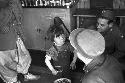 Soldier feeding girl bowl