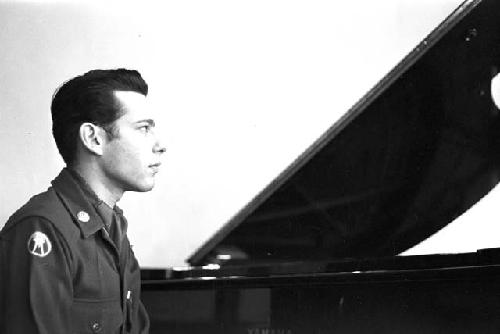 Portrait of officer looking away from piano