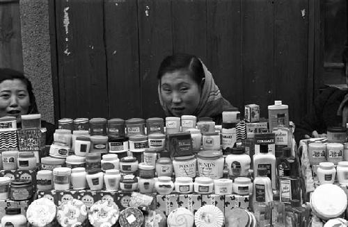 Women sitting behind stand