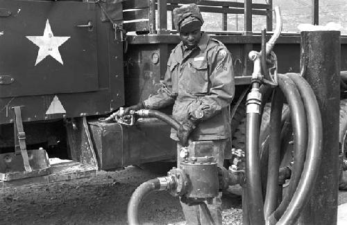 Soldier pumping gas into truck