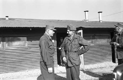 Soldiers speaking outside of base