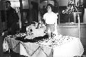 Portrait of woman standing in front of food table