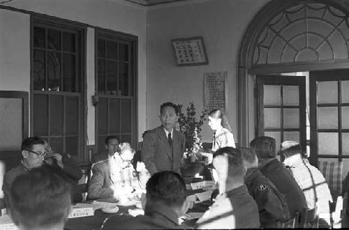 Portrait of man addressing participants in meeting