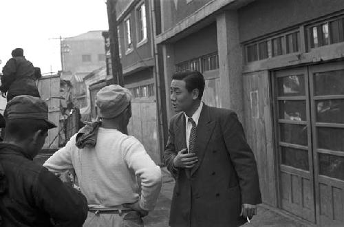 Men speaking to each other on the street 2