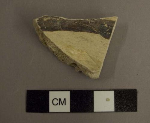 Ceramic body sherd, black pigment on white interior