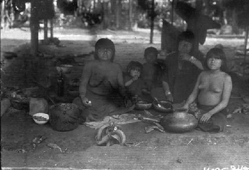 Family meal in front of hut