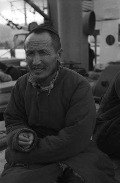 Turfan man, portrait, sitting on boat