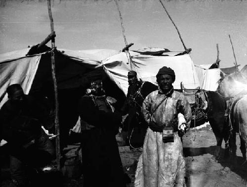 Mongol man and woman in front of booth