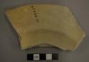 Ceramic dish sherd, flared rim, pigment on both