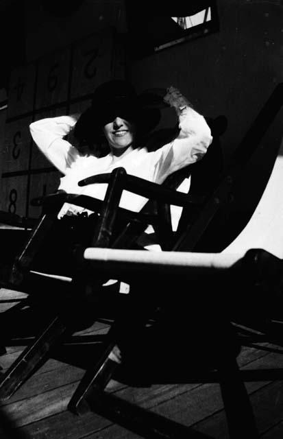 Woman sitting on deck of ship