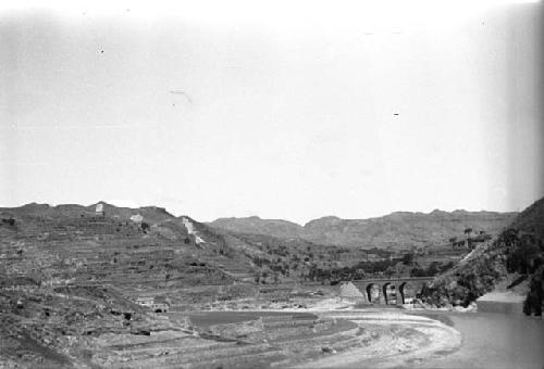 Landscape with terraced fields, river and bridge